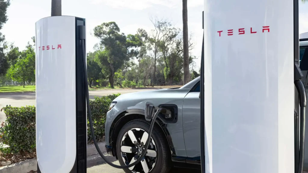 Tesla Supercharger for Business charging an electric vehicle at a commercial DC fast charging station.